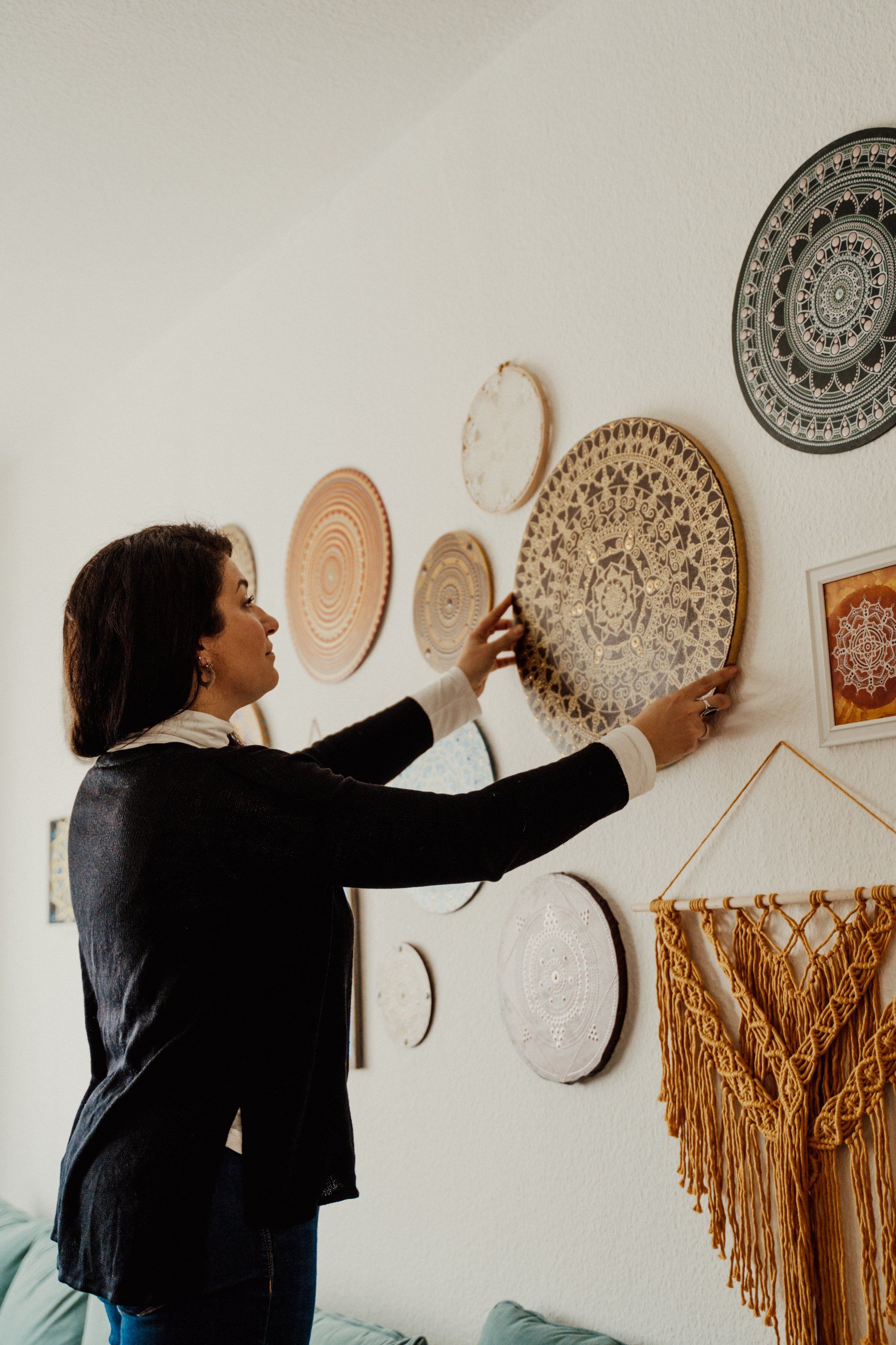 woman hanging up decorations on her wall