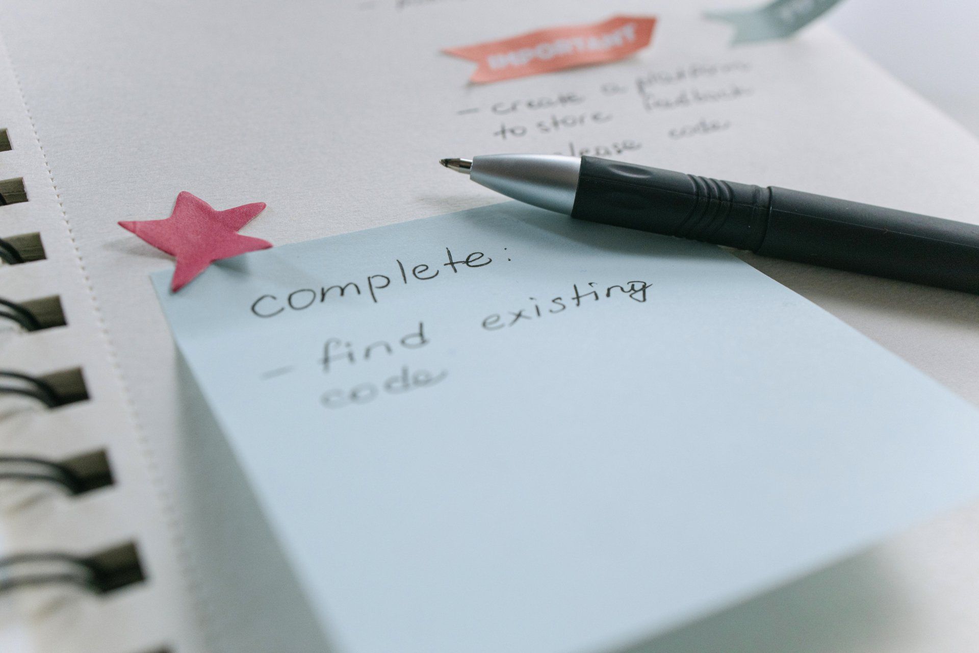 A pen is sitting on top of a note that says complete