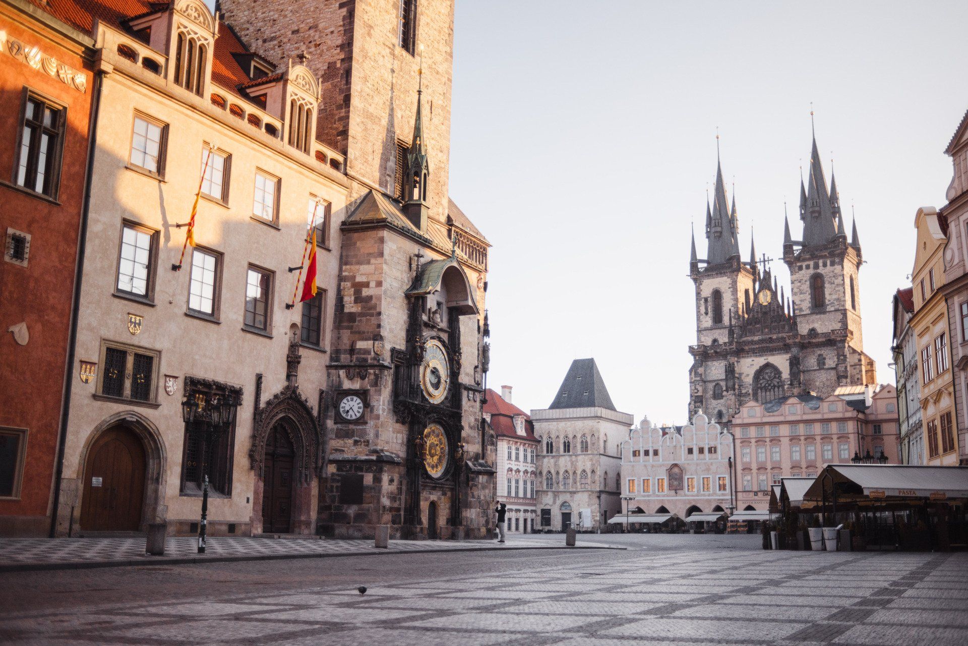 Historic European square with Gothic cathedral and old buildings in soft morning light
