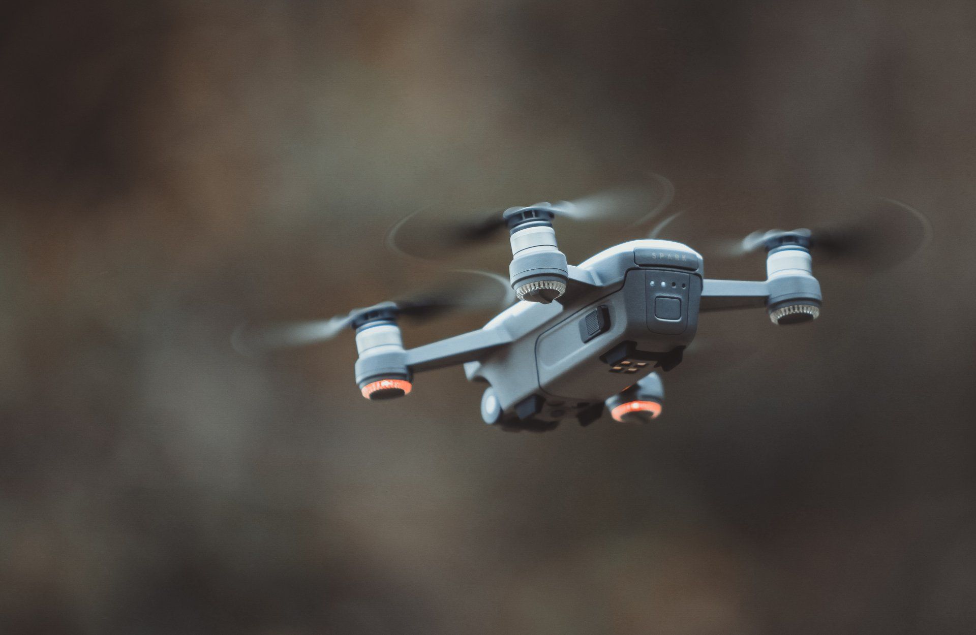 A small drone is flying in the air.