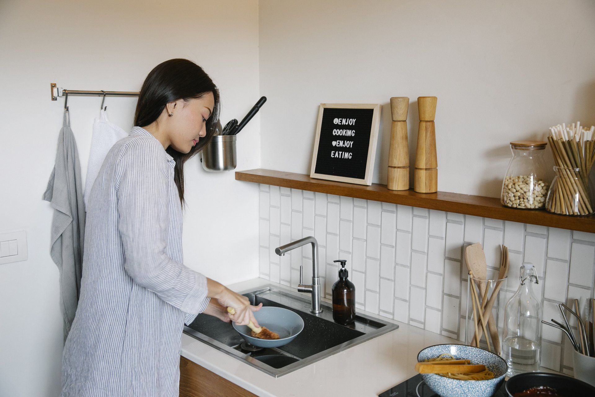 Woman using the kitchen sink