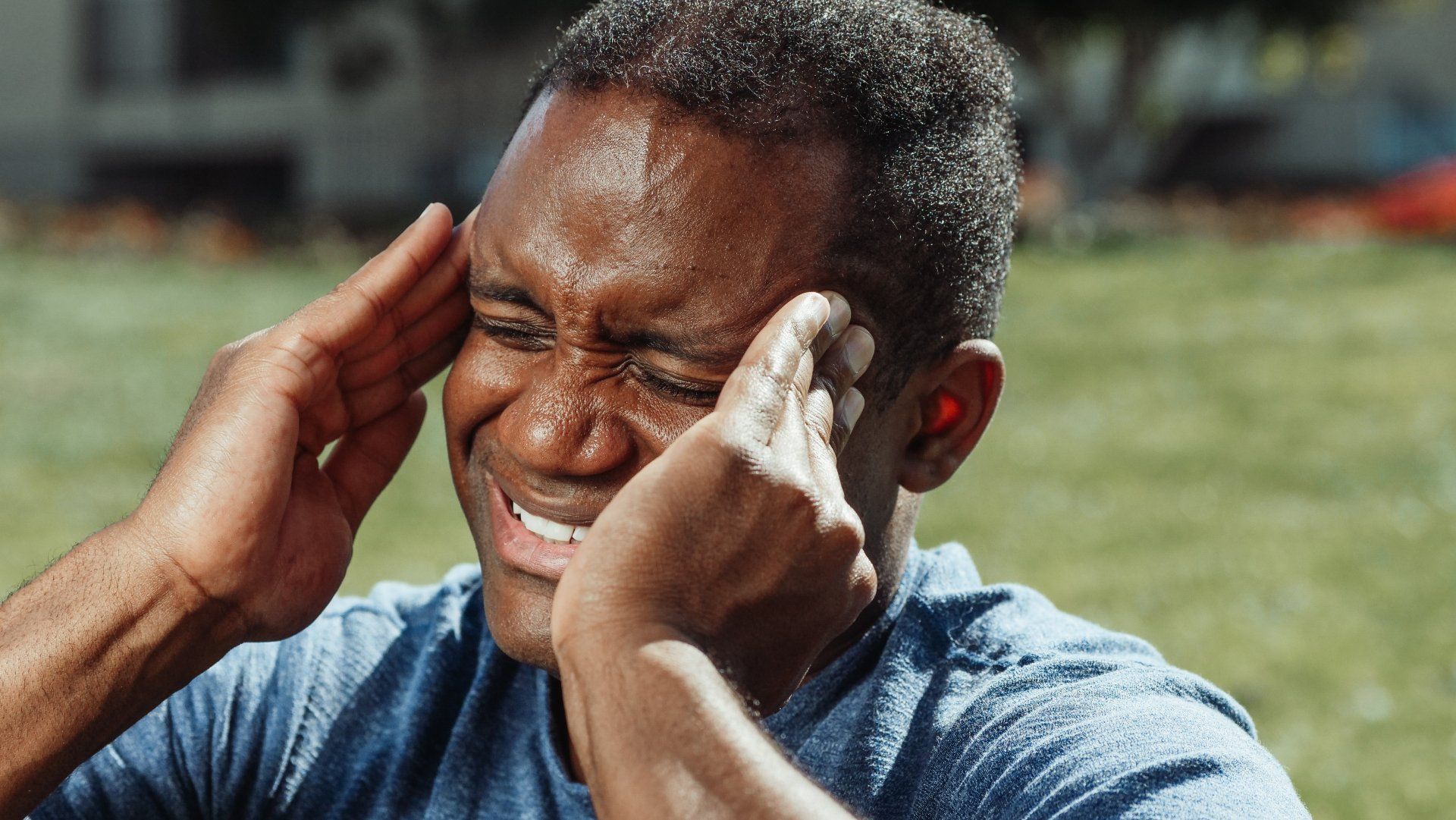 Man holding his temples due to strong headache pain.