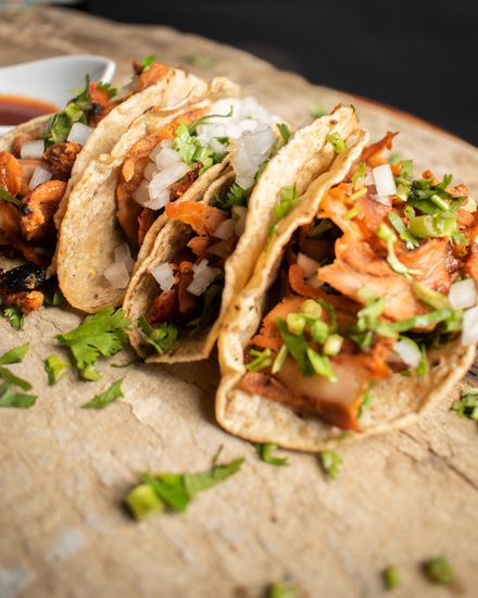 A close up of a plate of tacos on a table.