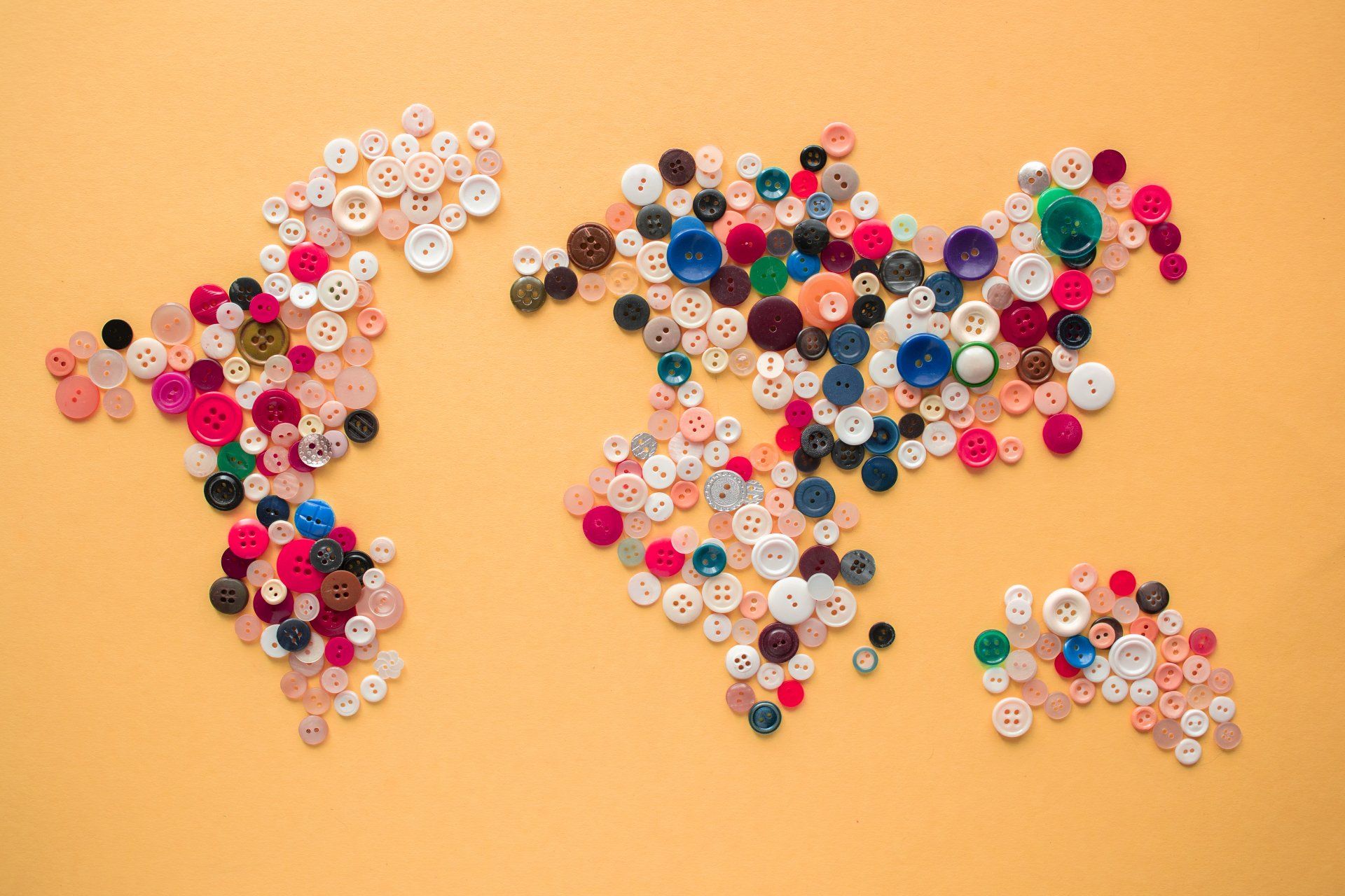 A map of the world made of buttons on a yellow background.