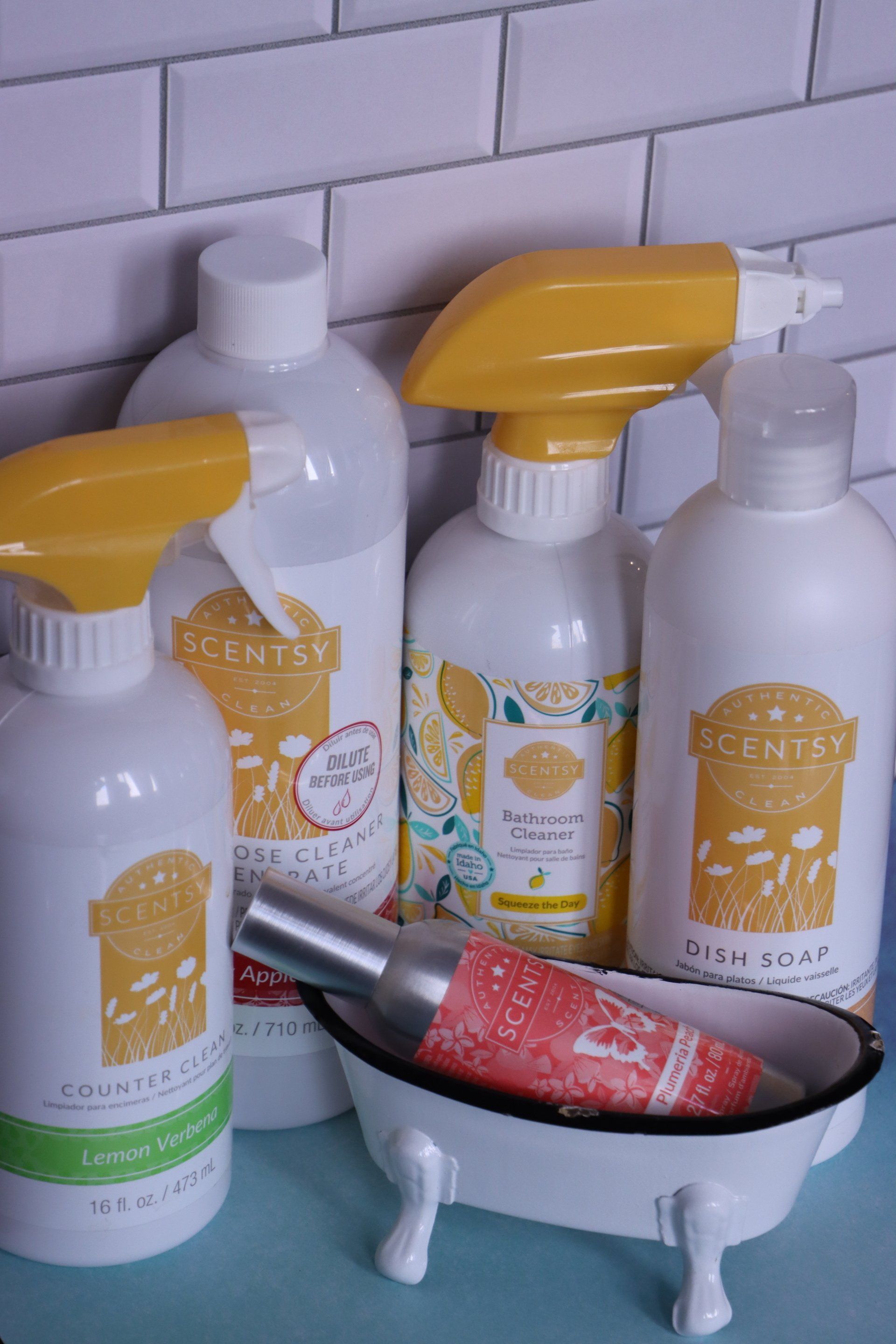 A bunch of bottles of cleaning products are sitting on a table.