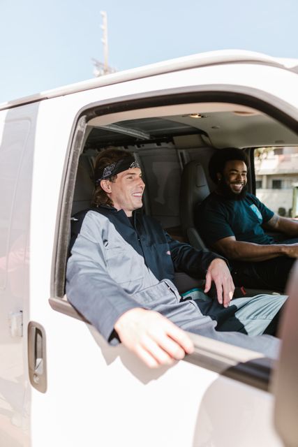 two men drive a moving van