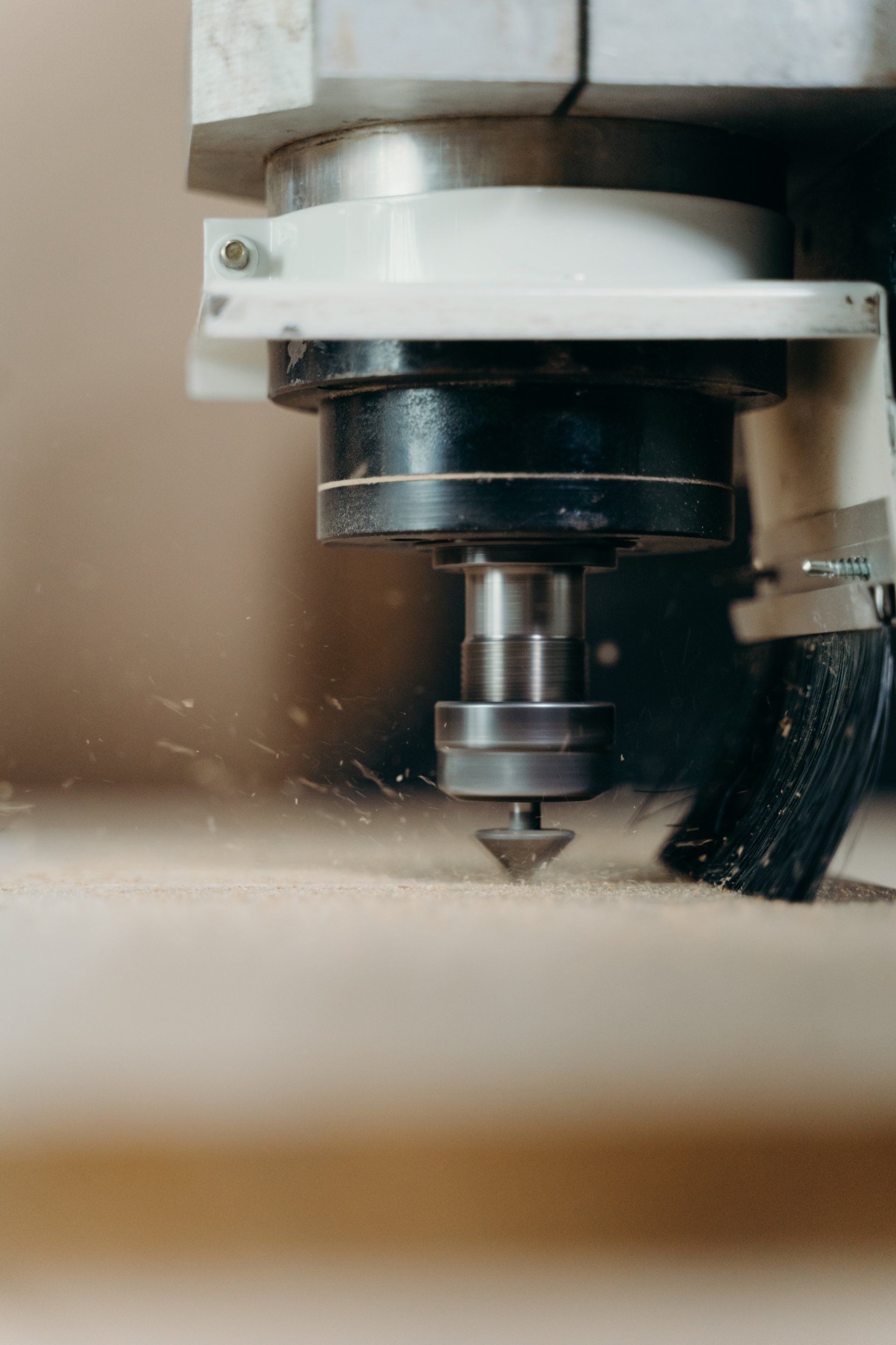 A close up of a machine cutting a piece of wood.