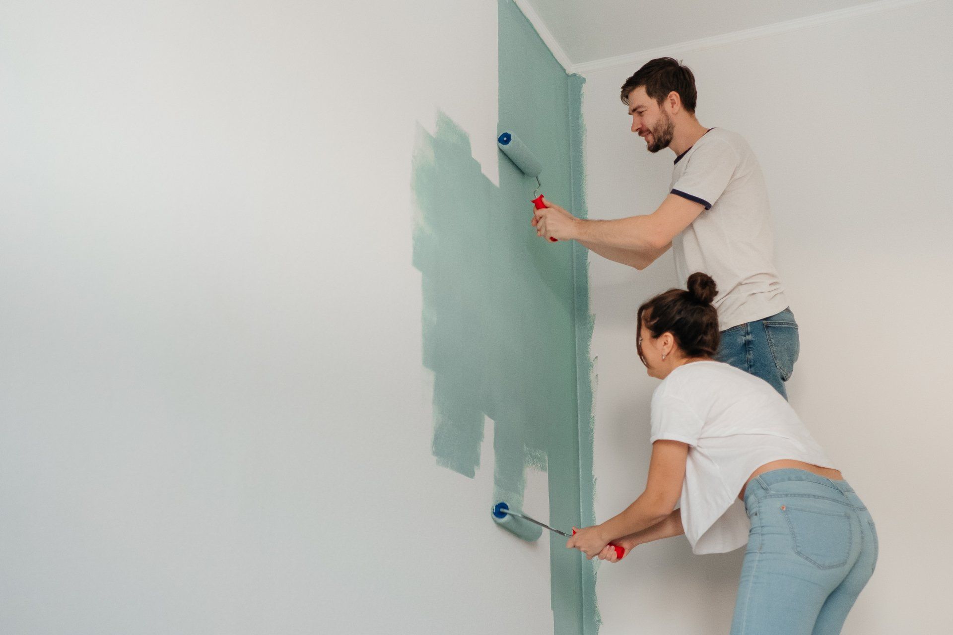 Couple painting wall