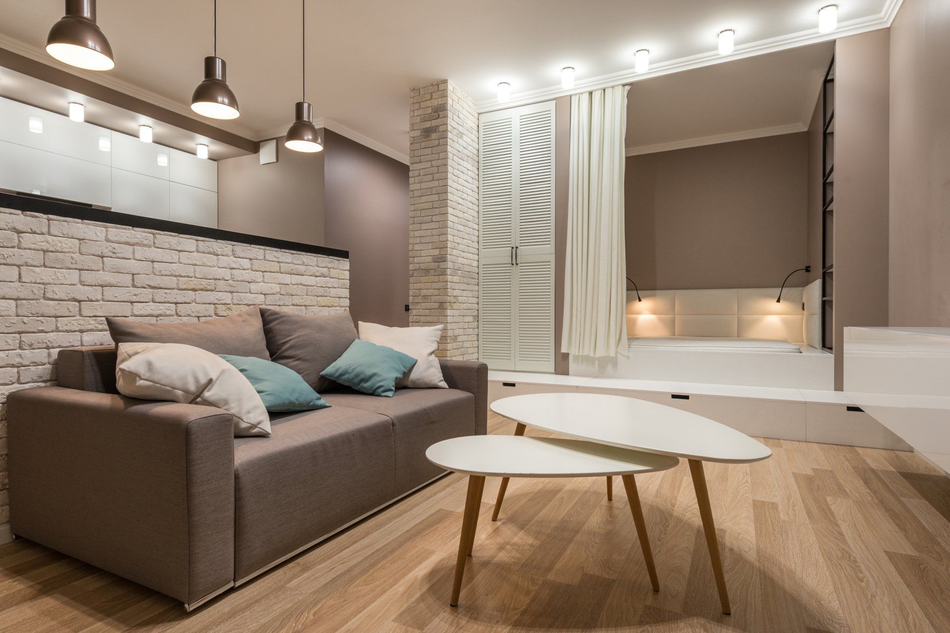 A living room with a couch and two coffee tables.