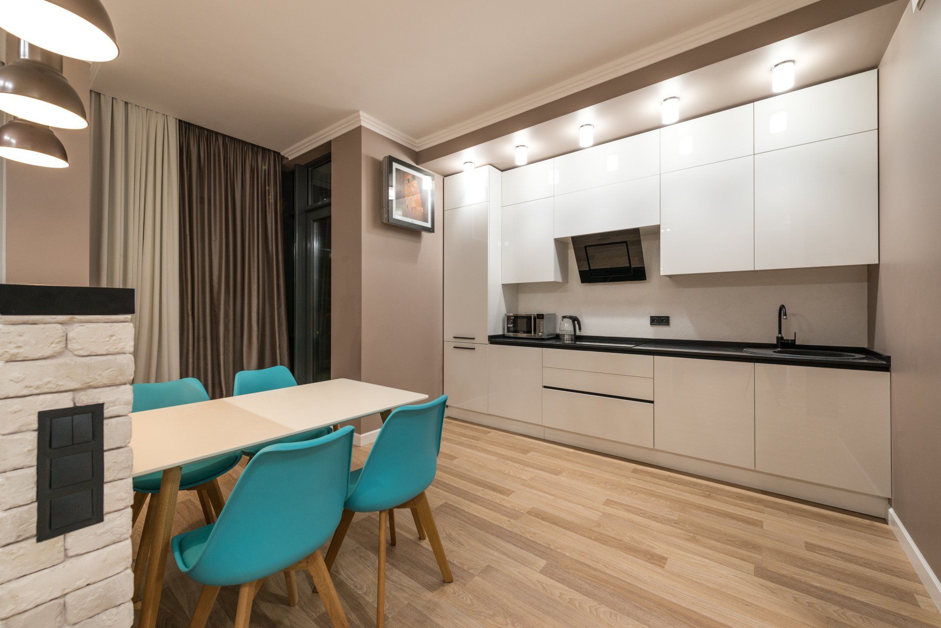 A kitchen with a table and chairs in it.