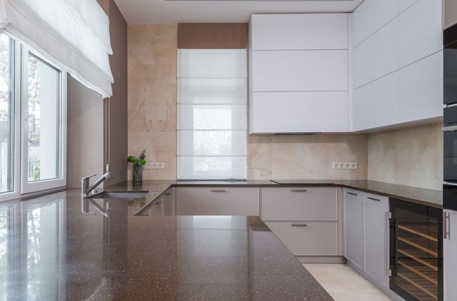 Granite kitchen countertop with plants and cabinets