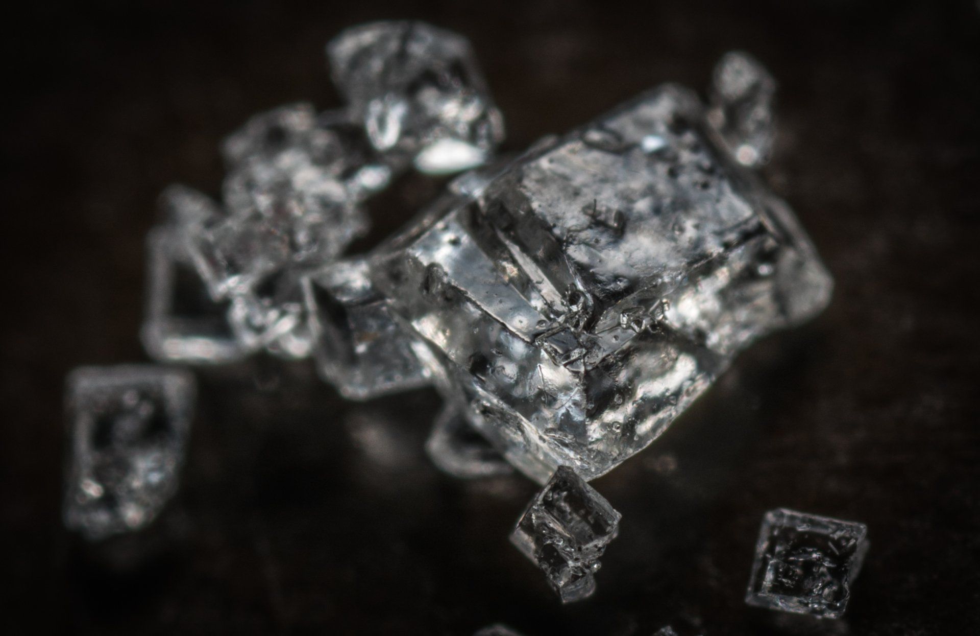 A close up of a piece of ice on a black surface.