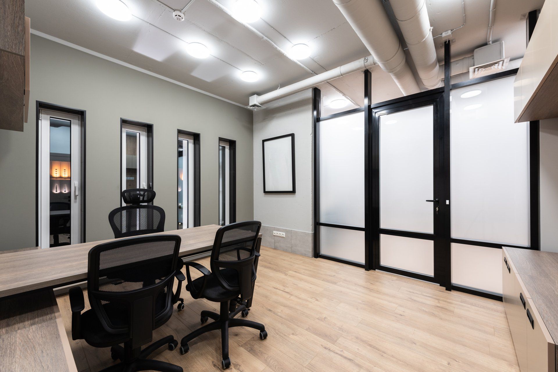 A conference room with a table and chairs in it.
