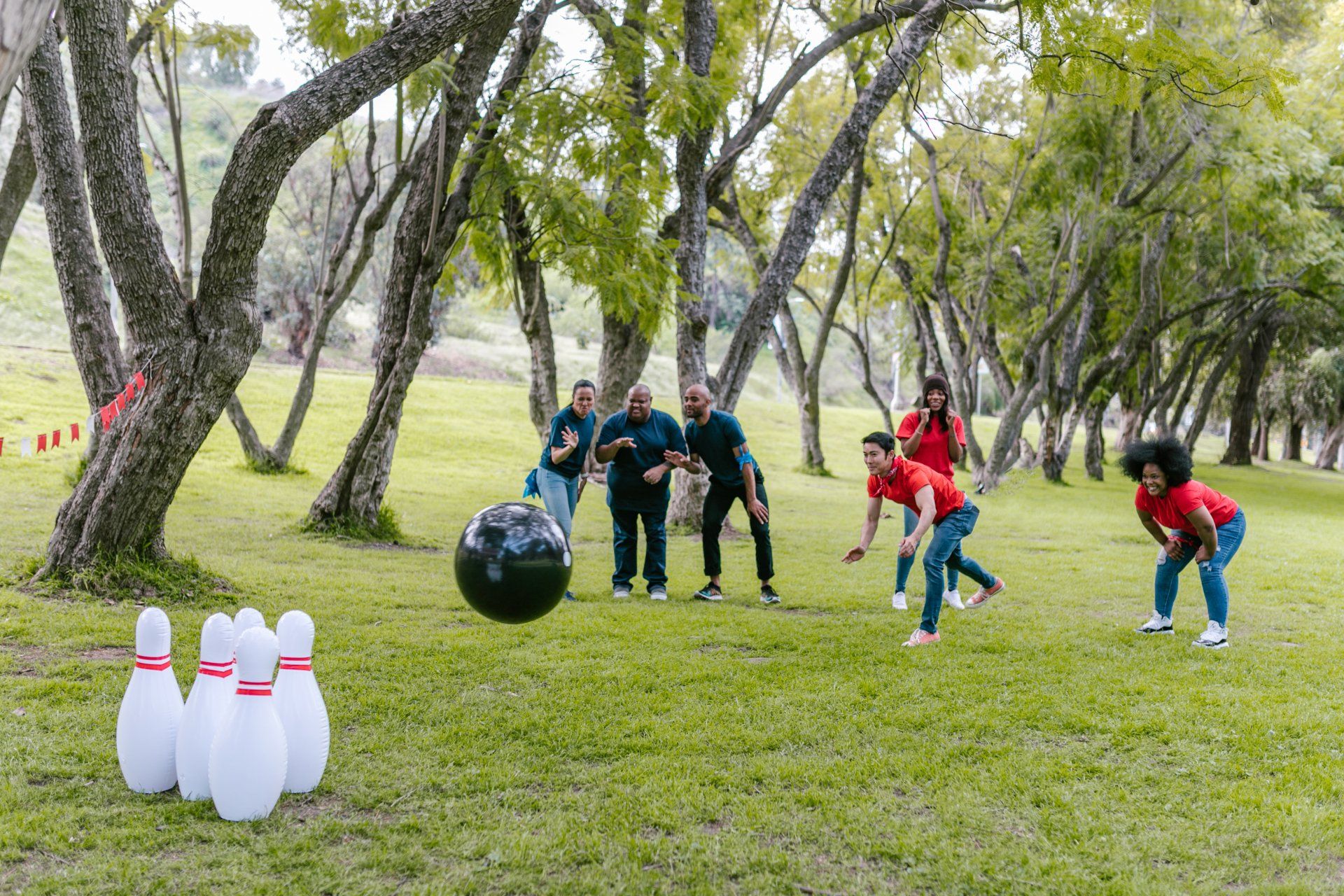 Few Adults in Black and Red Tshirts playing bowling — AMP Amusements In Rockhampton, QLD