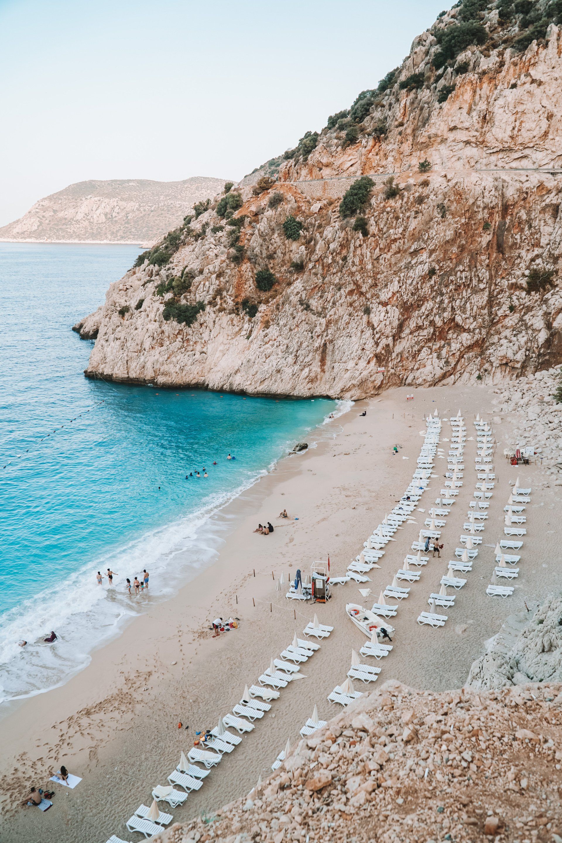 A beach with a lot of white umbrellas on it