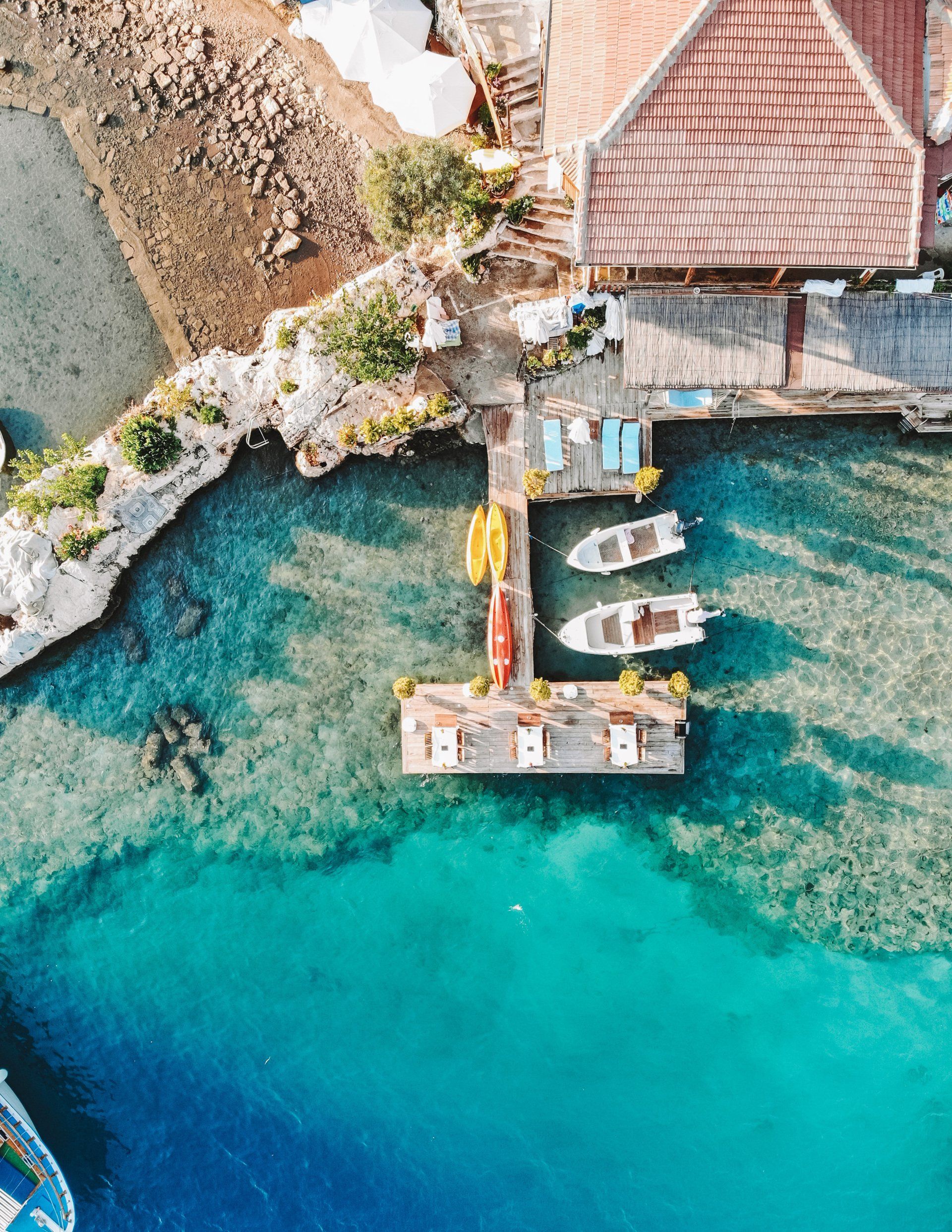 An aerial view of a dock with boats docked in the water.