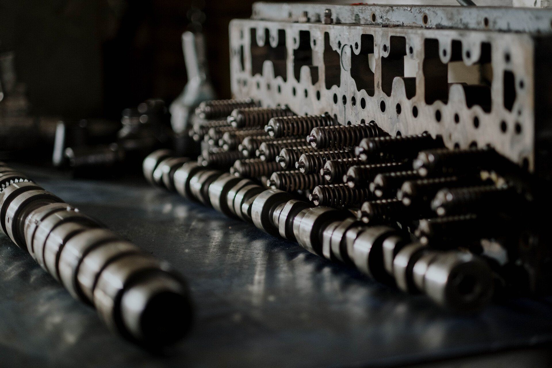 A black and white photo of a row of cylinder heads