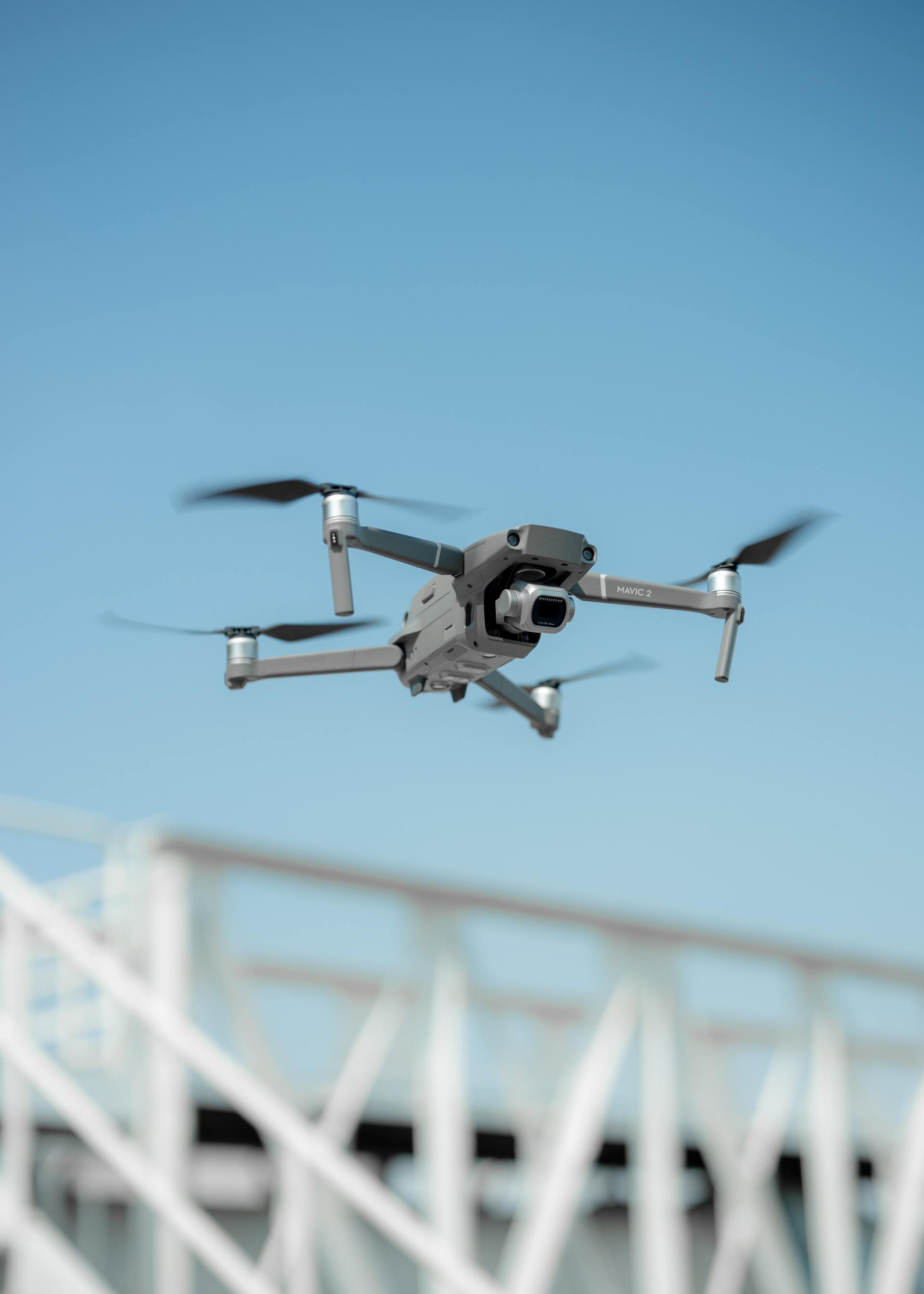 A drone is flying over a bridge in the sky