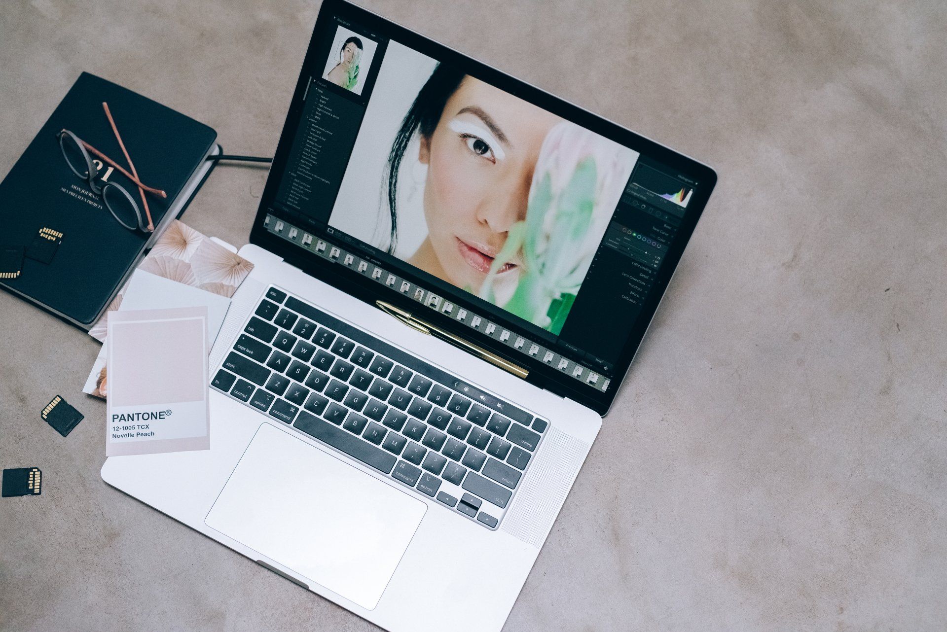 A laptop computer is open to a picture of a woman 's face.