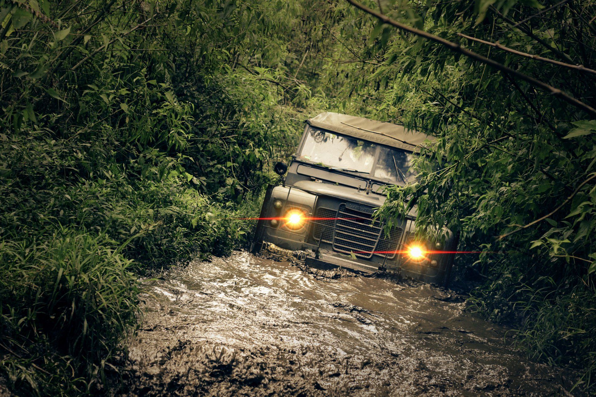 x4 vehicle crossing water during off-road expedition