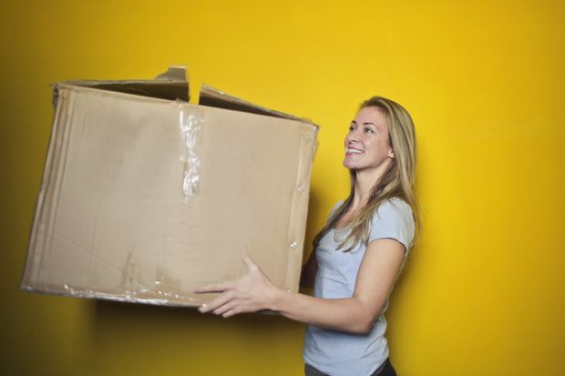 Woman carrying moving box