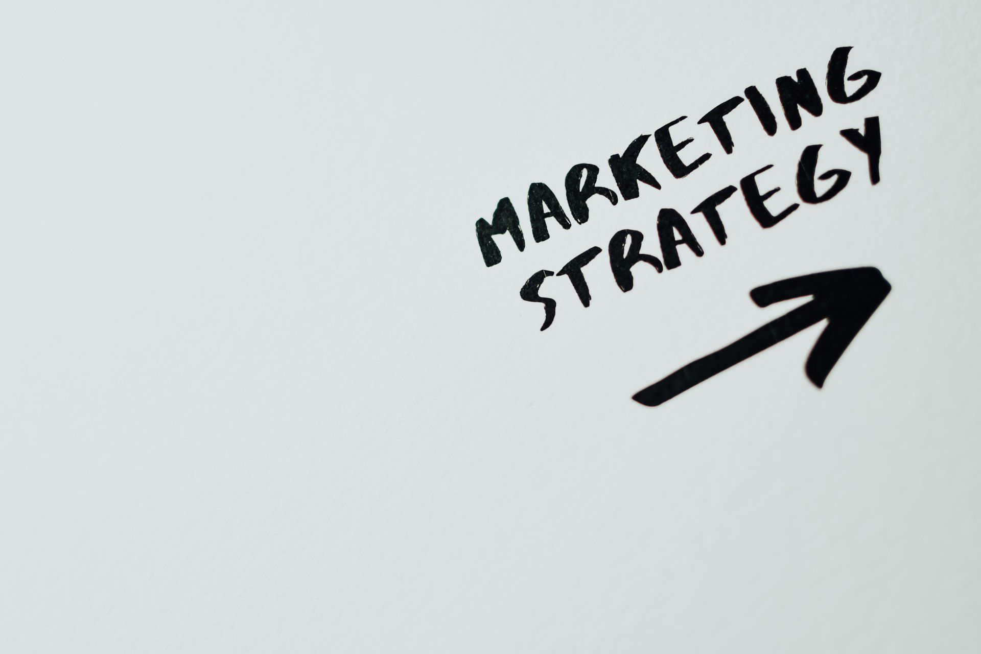 A white board with the words marketing strategy written on it