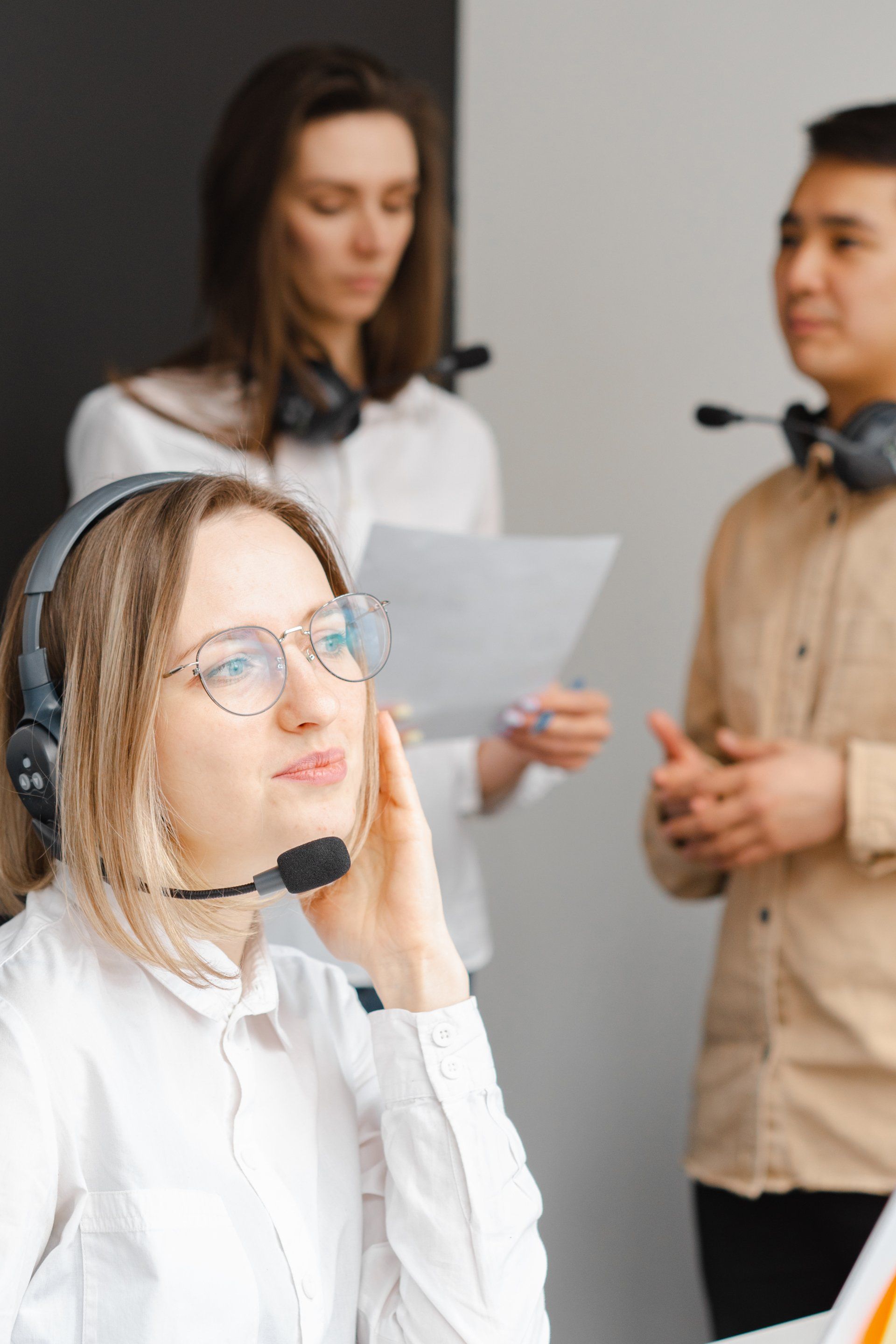 Young handsome male customer support phone operator with headset working in call center.