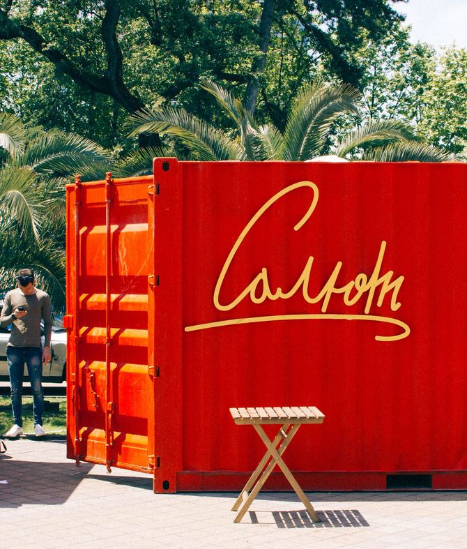 Red shipping container with gold cursive 