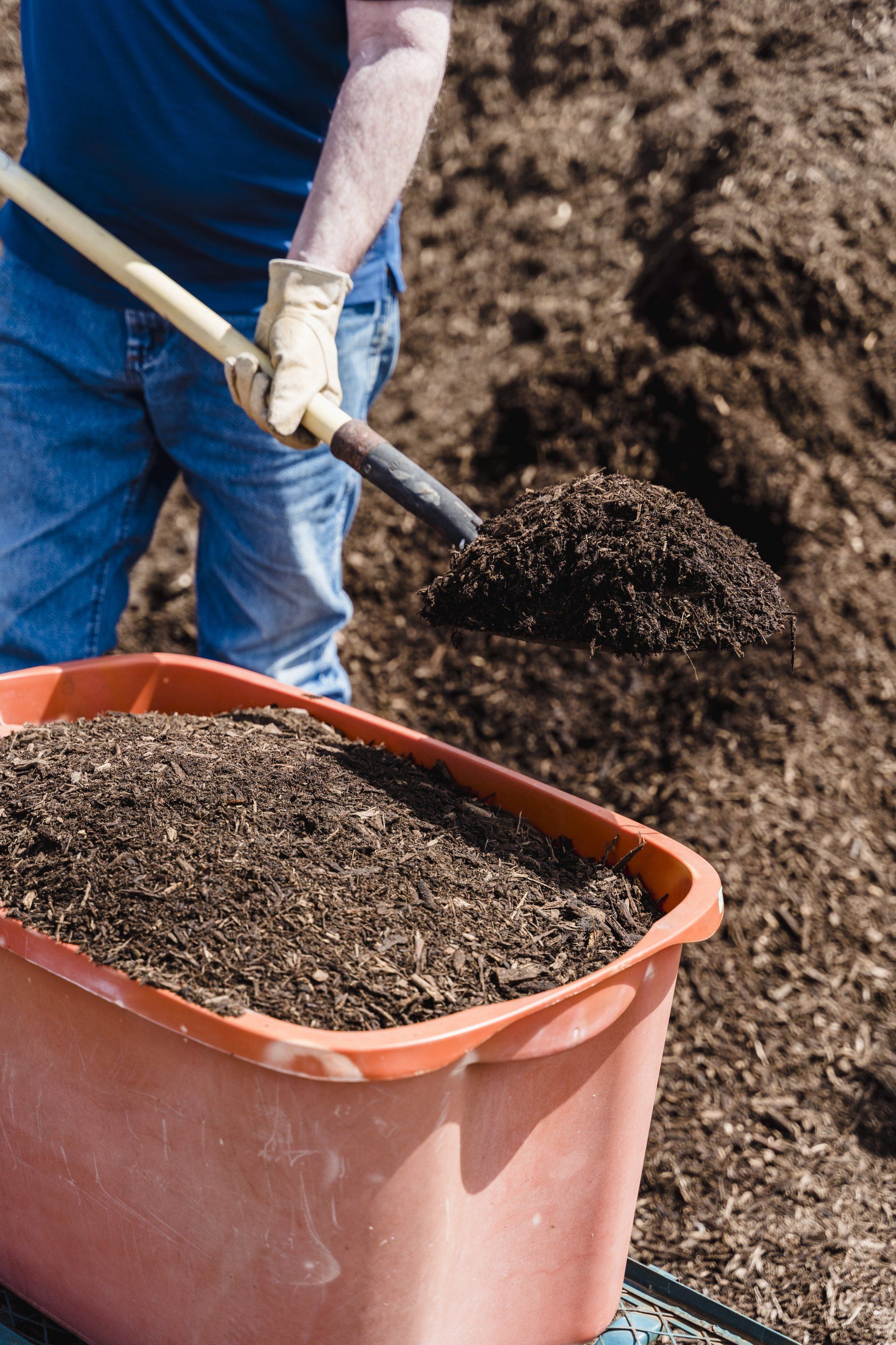 a person with a shovel and compost