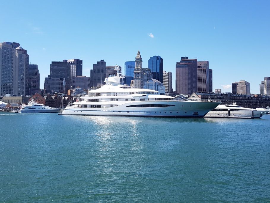 A group of boats are docked in a harbor.