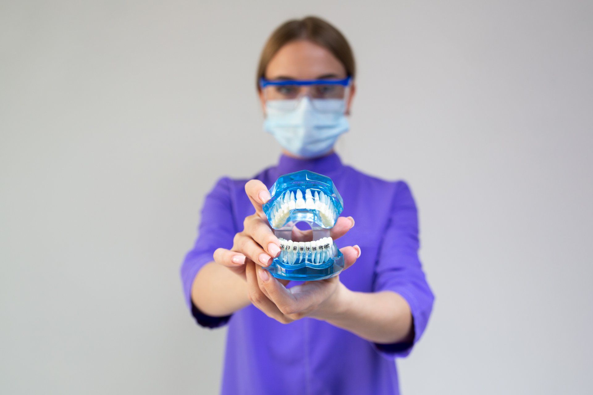 Dentist holding a model of teeth | Sleep Apnea oral appliances Lees Summit MO