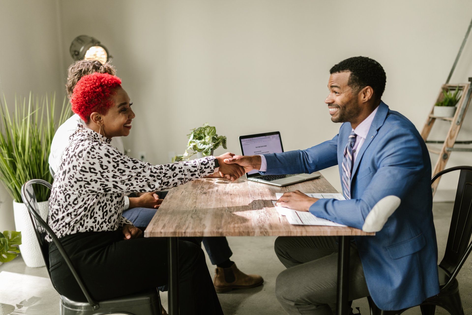 Businessman shaking hand to woman