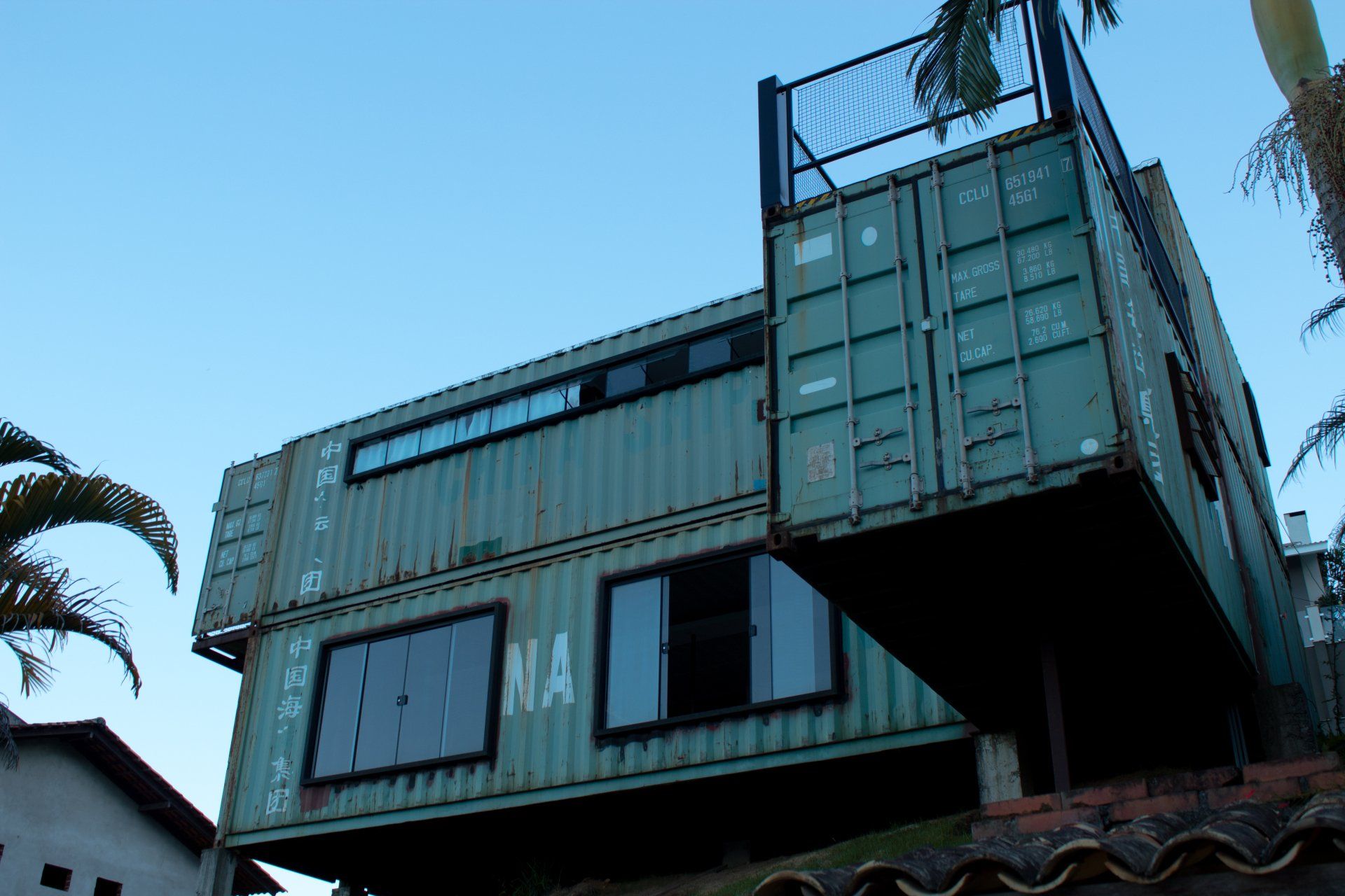 A building made out of shipping containers has the letters na on the side