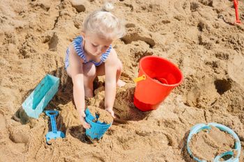 Pony on wheels - child playing with beach gear