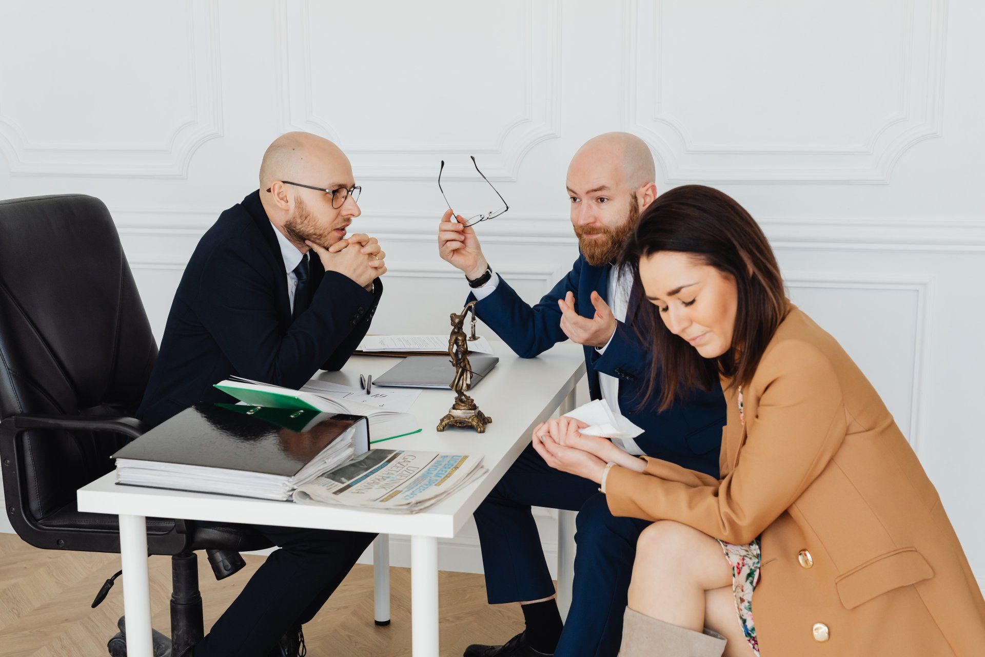 A mediator facilitating a man and a woman through a discussion to resolve a conflict