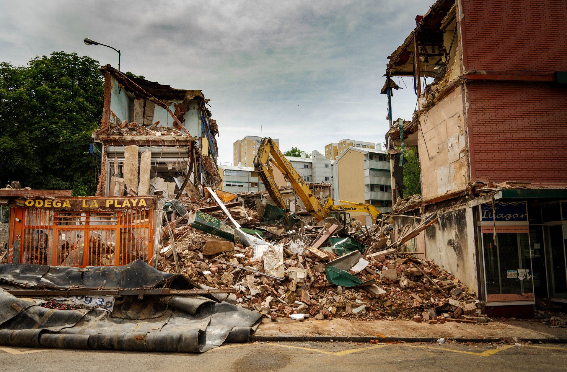 A building that is being demolished has a sign that says goptica la playa