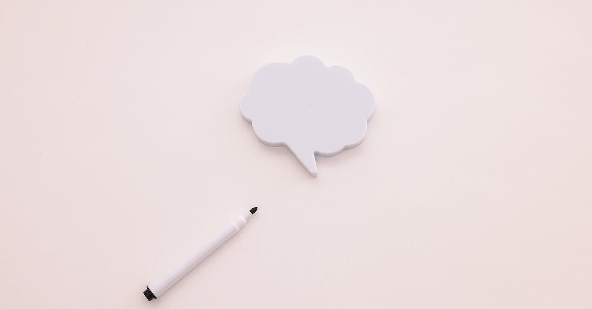 White speech bubble with a pencil on a pale pink background