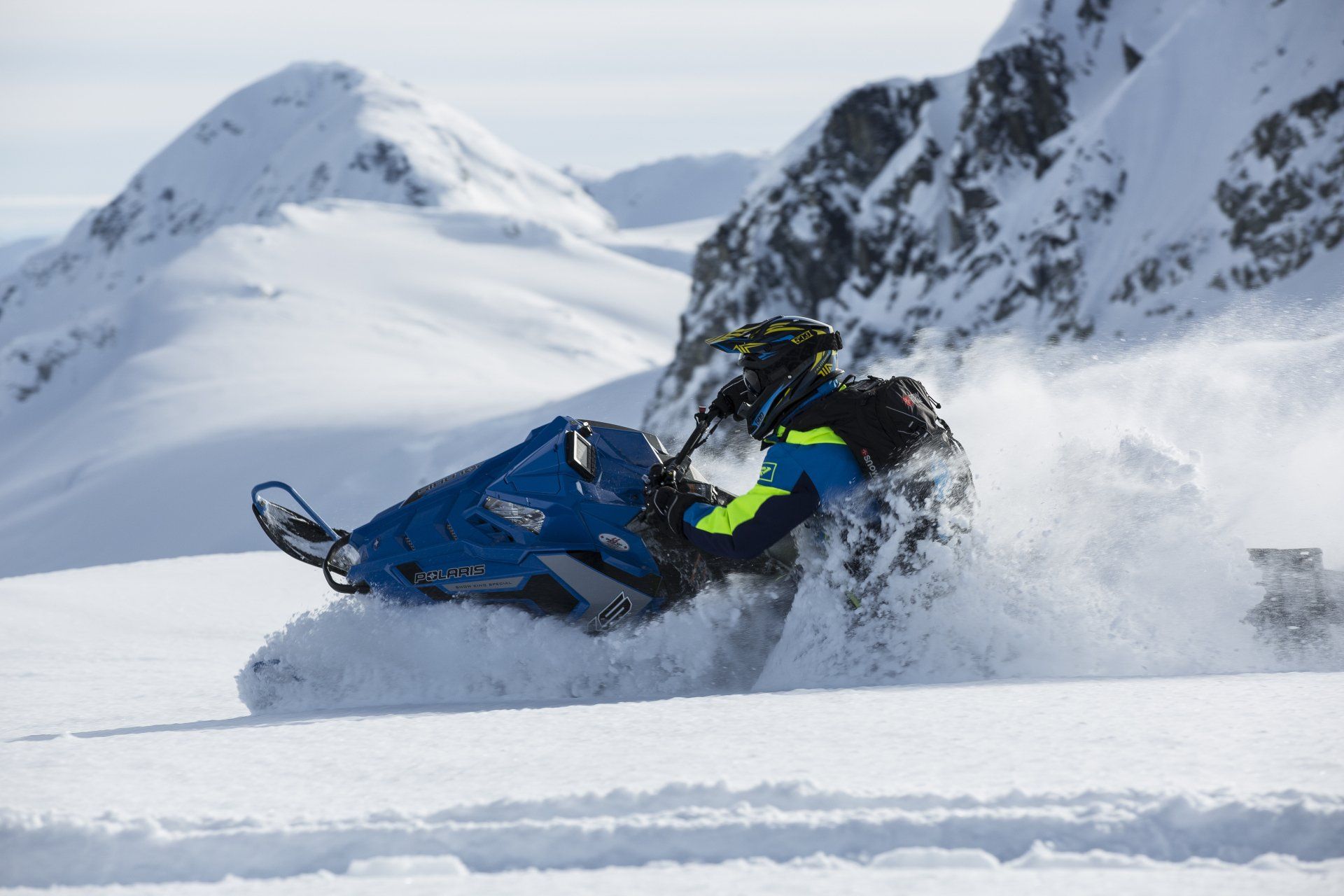 A person is riding a snowmobile in the snow.