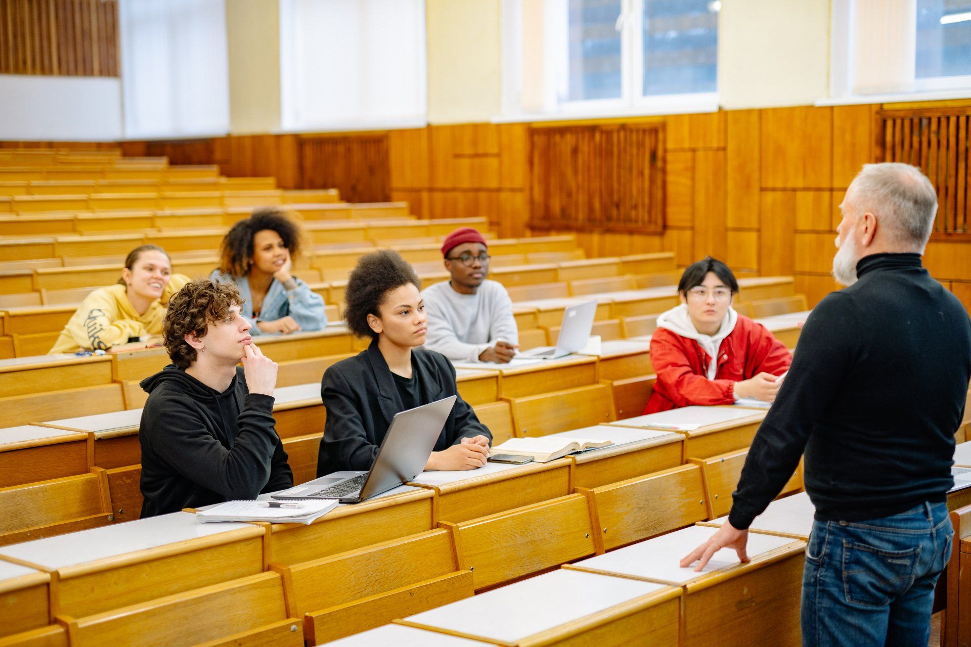 man in black turtle neck teaching students