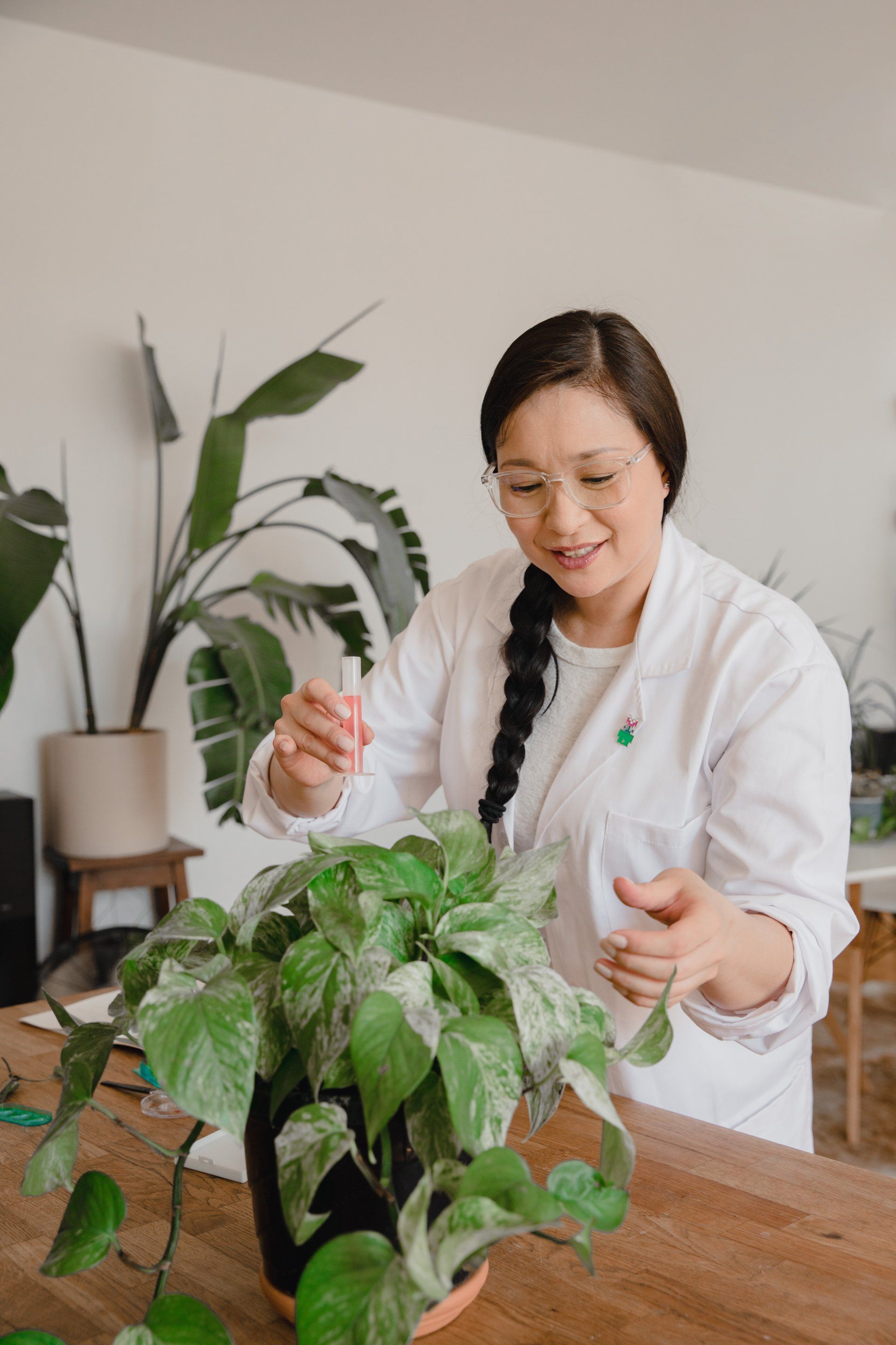 a woman with a plant in front of her