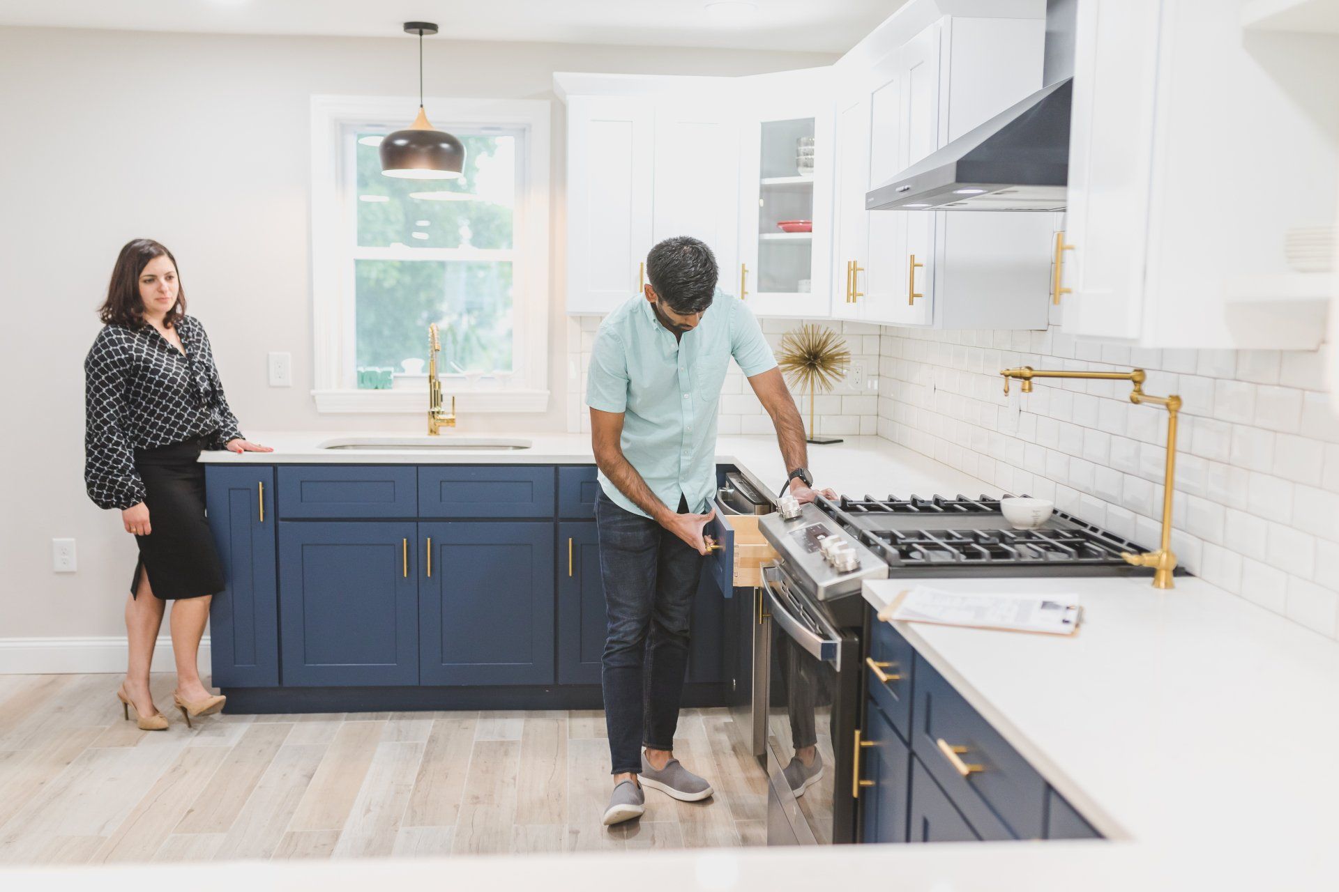 A man & a woman inspecting the kitchen - pre-inspection process of the home buying and selling process