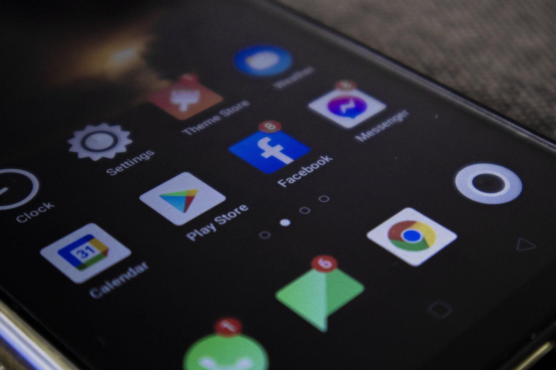 a close up of a cell phone with a facebook icon on it