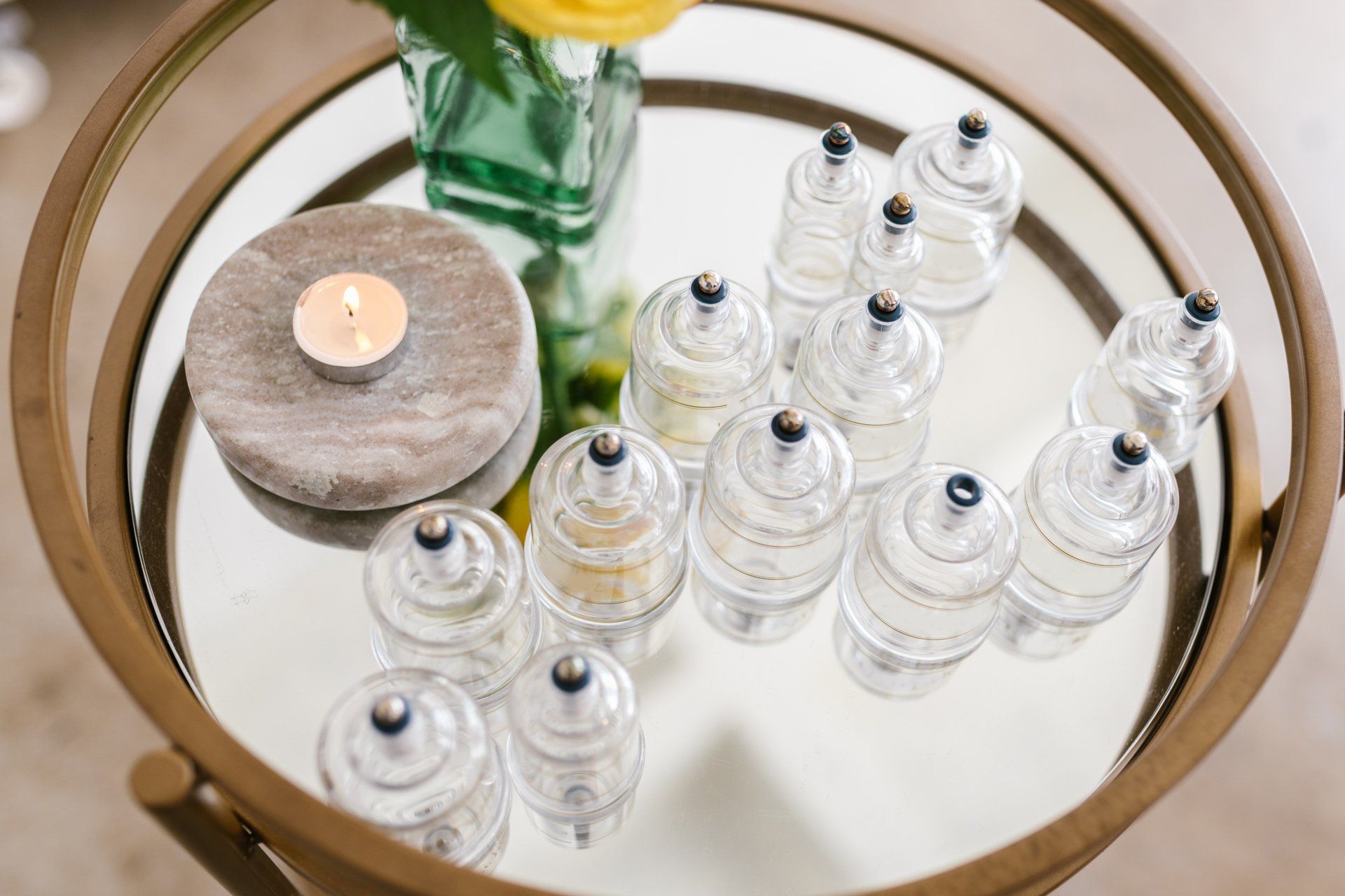 a table with tray with 12 medical cups on it