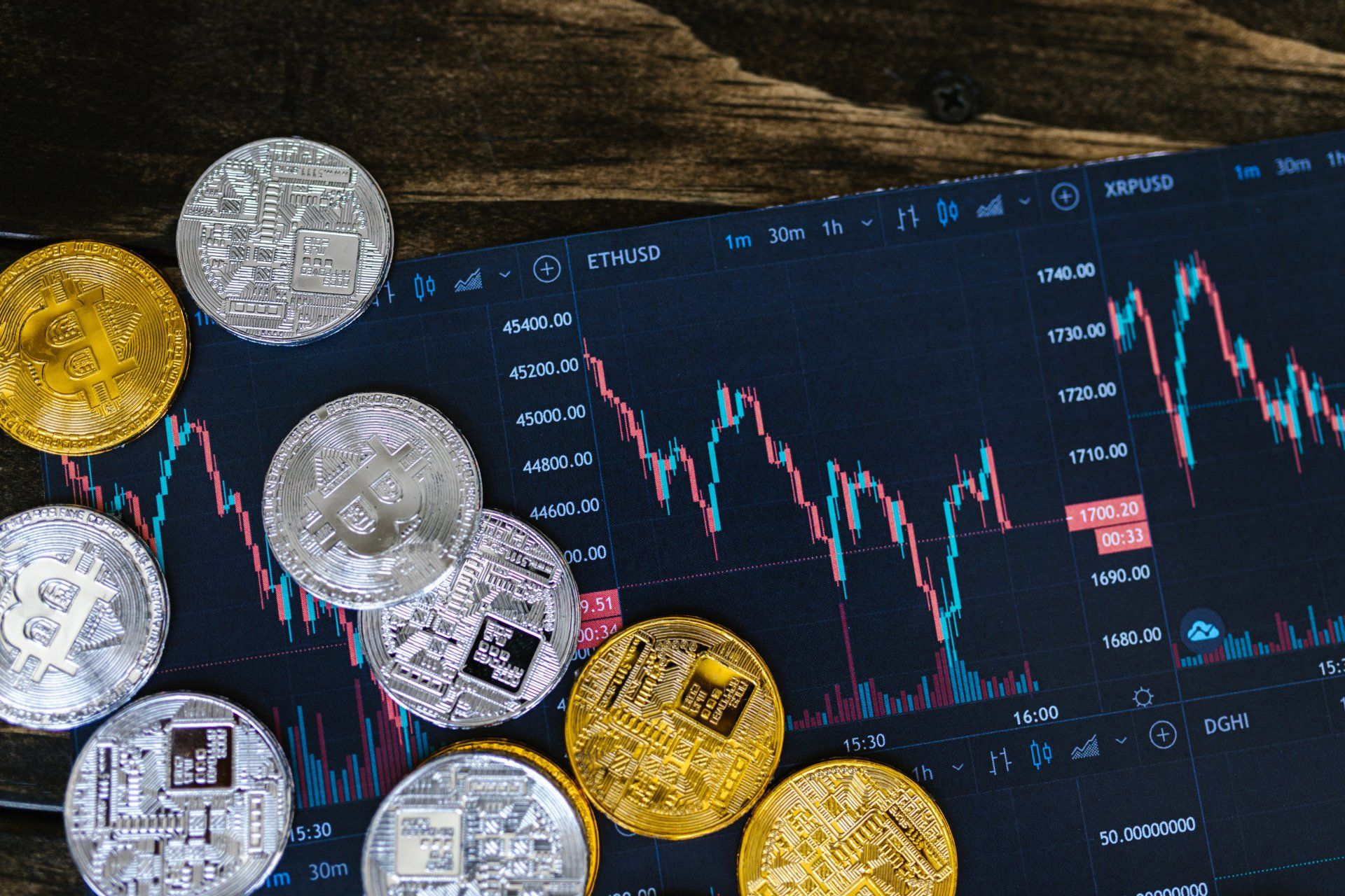 A bunch of coins are sitting on top of a computer screen.