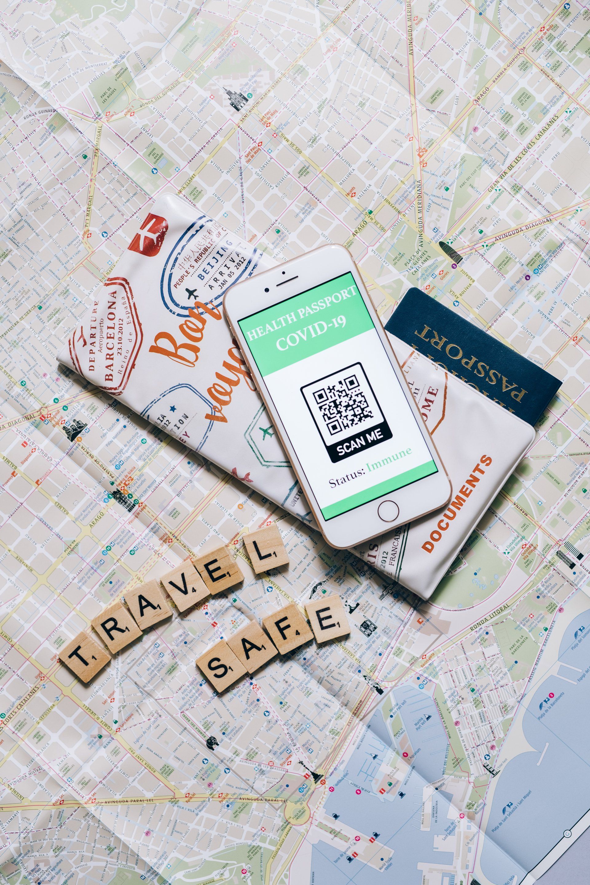 Phone with COVID-19 pass, passport, travel documents on map, with 
