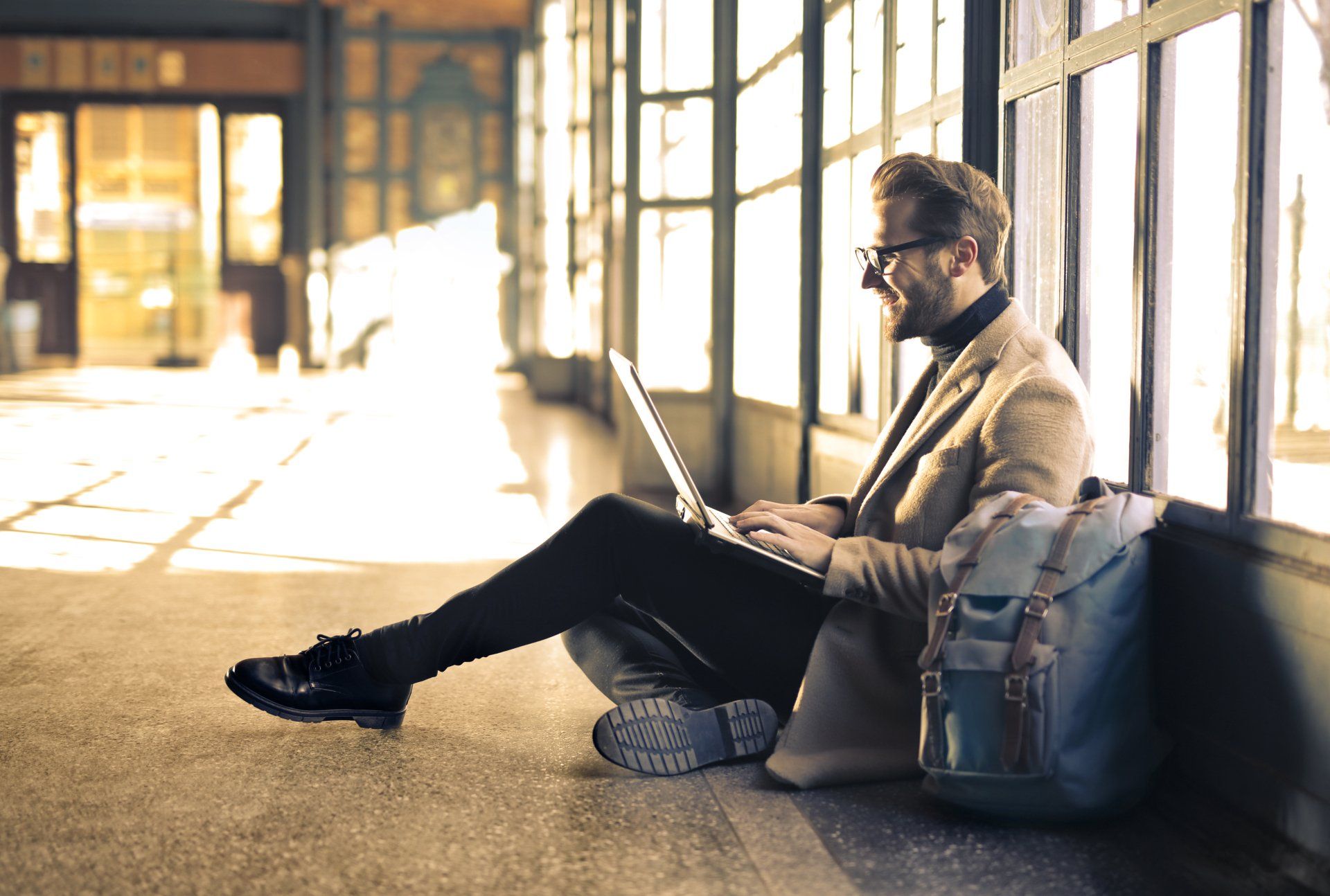 Man sitting on the floor with computer