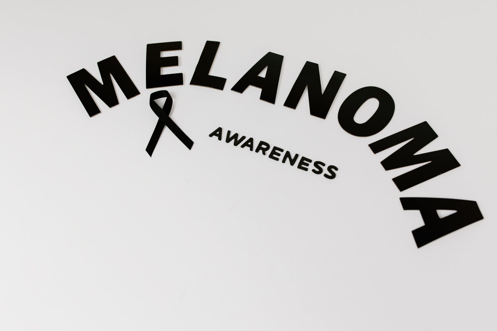 A black and white logo for melanoma awareness