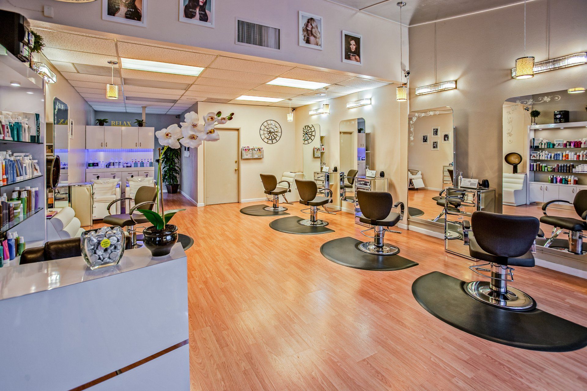 A hair salon with a lot of chairs and mirrors.
