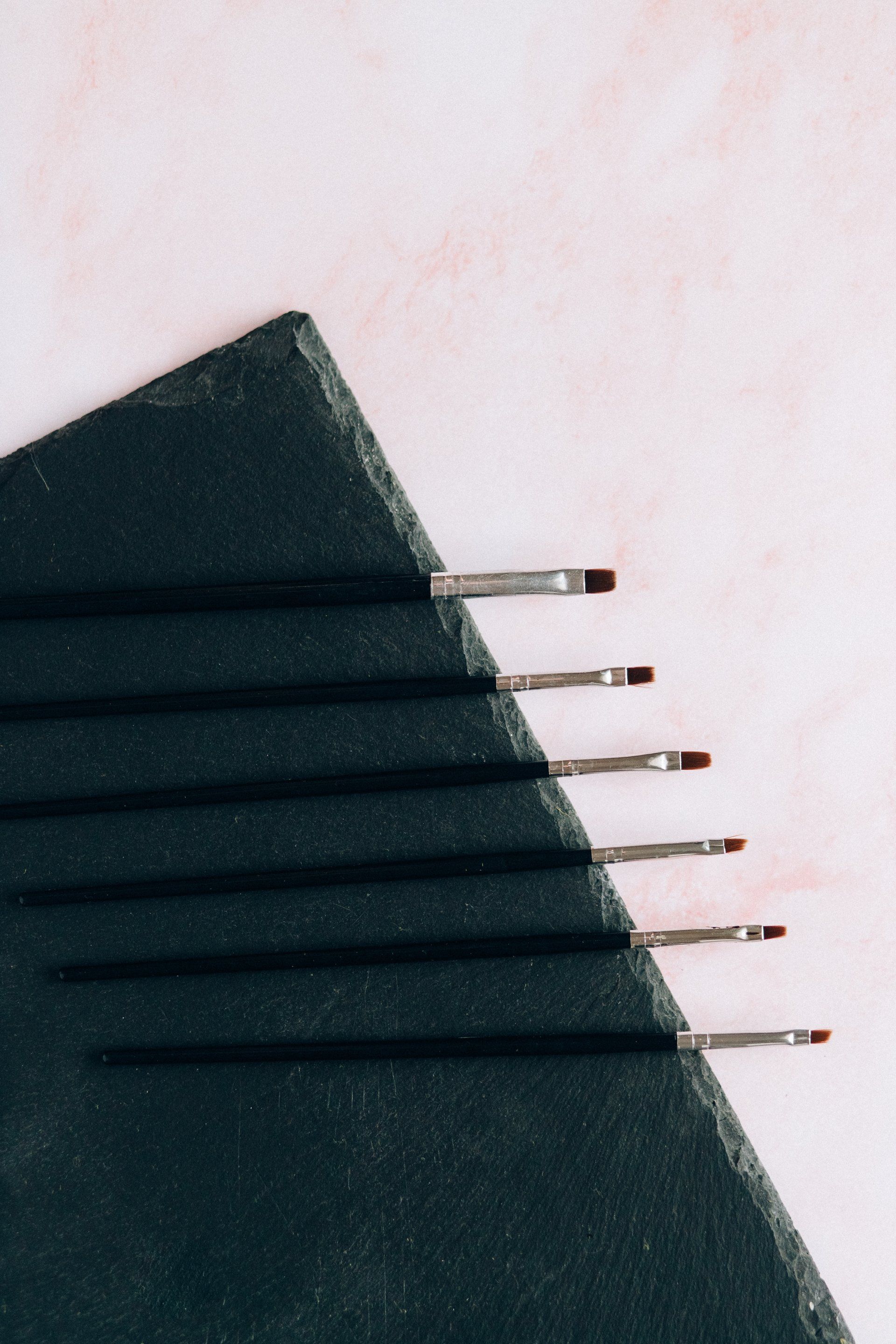 A close up of a row of hair clips on a piece of paper
