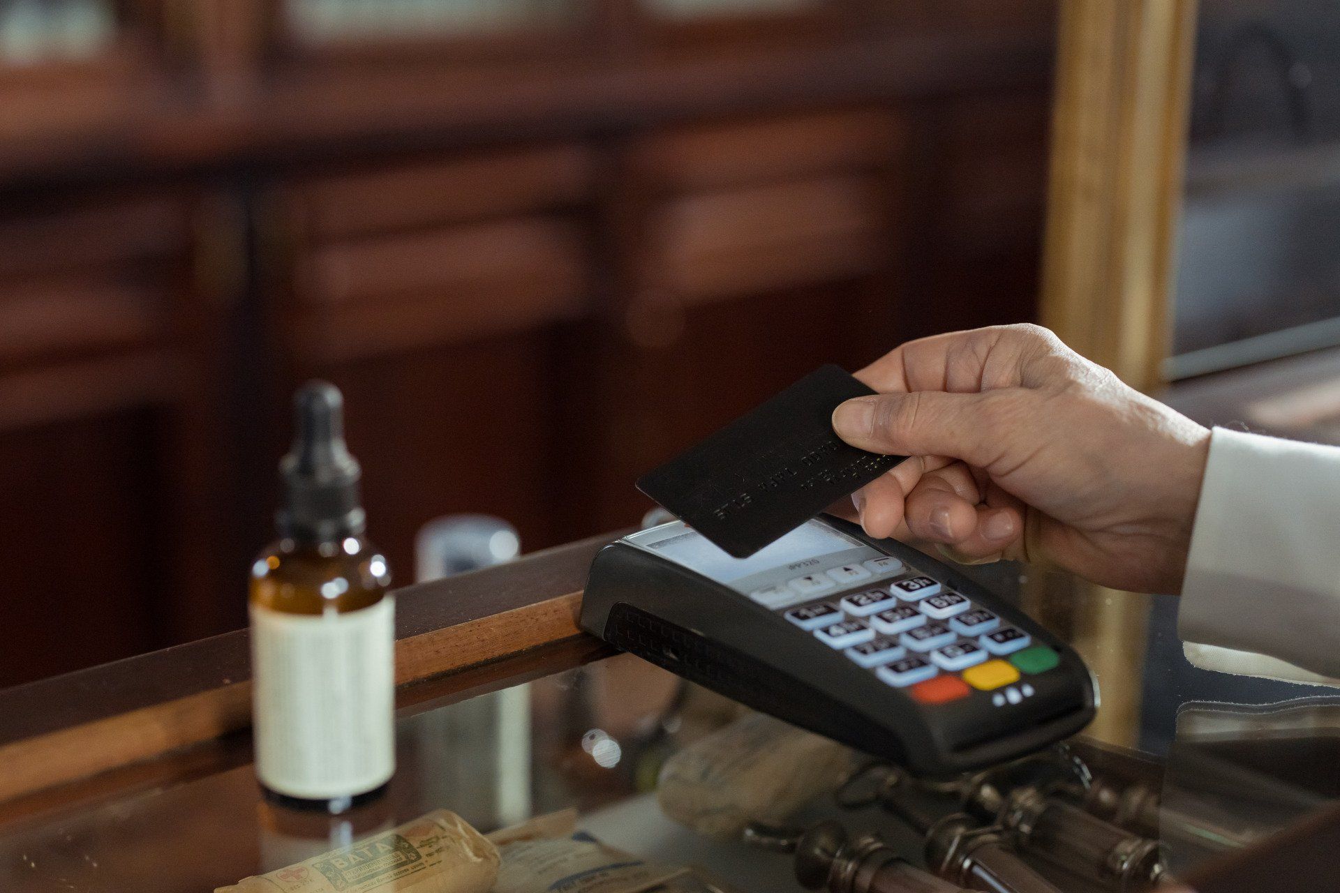 man doing a transaction with swiping machine
